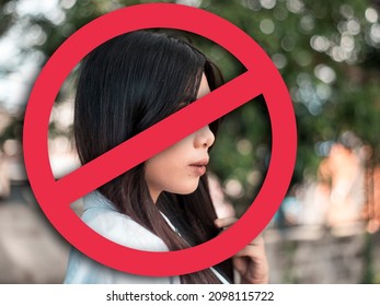 A depressed young woman after being called out, blocked or shunned in social media or in person. Cancel culture concept. With stop sign graphic. - Shutterstock ID 2098115722