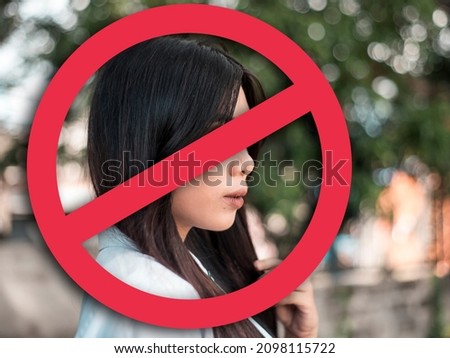 A depressed young woman after being called out, blocked or shunned in social media or in person. Cancel culture concept. With stop sign graphic. Stock photo © 