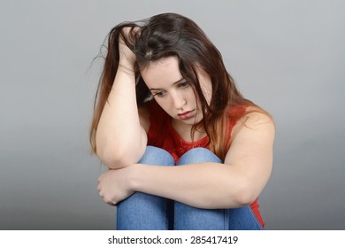 Depressed Young Woman Crouching On Floor