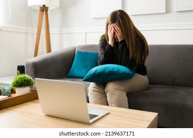 Depressed Young Woman Crying While Talking About Her Problems During A Virtual Therapy Session 