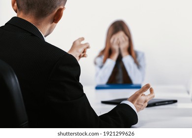 Depressed Young Woman During A Conversation With The Boss Who Points Out Her Mistakes