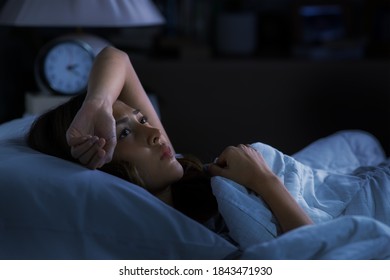 Depressed Young Woman Lying In Bed Cannot Sleep From Insomnia