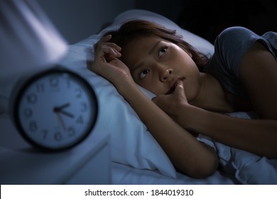Depressed young woman lying in bed cannot sleep from insomnia - Shutterstock ID 1844019310