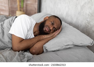 Depression Concept. Portrait Of Upset African American Man Lying In Bed In The Morning And Thinking. Sad Black Male Feeling Lonely Or Stressed, Suffering From Lack Of Sleep, Distraught