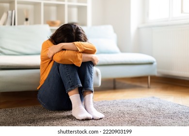 Depression Concept. Portrait Of Upset Young Middle Eastern Woman Crying At Home, Depressed Millennial Lady Burying Head In Knees While Sitting On Floor In Room, Suffering Mental Breakdown, Copy Space - Shutterstock ID 2220903199