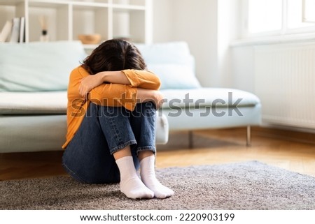 Depression Concept. Portrait Of Upset Young Middle Eastern Woman Crying At Home, Depressed Millennial Lady Burying Head In Knees While Sitting On Floor In Room, Suffering Mental Breakdown, Copy Space