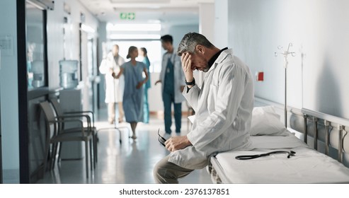 Depression, grief or fail with a mature doctor in a hospital looking unhappy for healthcare or medical. Stress, mistake or loss with a sad man medicine professional in a professional medicare clinic - Powered by Shutterstock