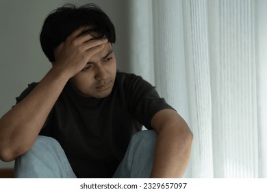 Depression and mental illness. Asian man disappoint, sad after receive bad news. Stressed boy confused with unhappy problem, arguing with girlfriend, cry and worry about unexpected work, down economy.