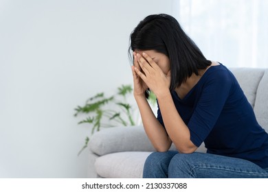 Depression and mental illness. Asian woman disappointed, sad after receiving bad news. Stressed girl confused with unhappy problems, arguing with boyfriend, cry and worry about unexpected pregnancy. - Shutterstock ID 2130337088