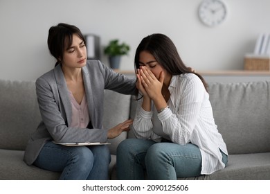 Depression, Nervous Breakdown Concept. Compassionate Psychologist Providing Help To Unhappy Arab Lady During Session At Mental Health Clinic, Assisting Female Patient