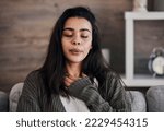 Depression, sad and woman with eyes closed in home thinking of problems. Anxiety, mental health and unhappy, depressed and lonely female on sofa in living room trying to calm down and relax in house.