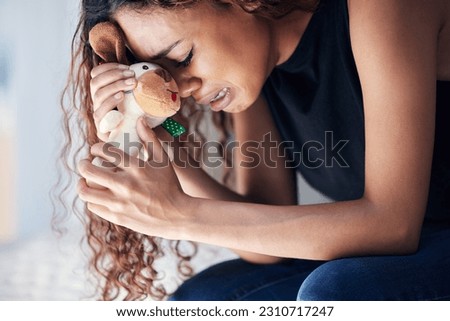 Depression, tears and woman with teddy bear in home for grief, miscarriage or mourning death of kid. Sad mother, crying and person with pain, anxiety or trauma problem, stress or frustrated in house