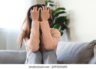 Depression in teenage concept, Young women covering her face feeling anxious and unhappy lock themselves at home sad emotional alone, and have mental disorders. - Powered by Shutterstock