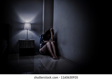 Depression Woman Alone In The Dark Room. Mental Health Problem, PTSD Is Post-traumatic Stress Disorder.