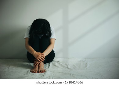 The Depression Woman  Hug Her Knee And Cry. Sad Woman Sitting Alone In A Empty Room. 