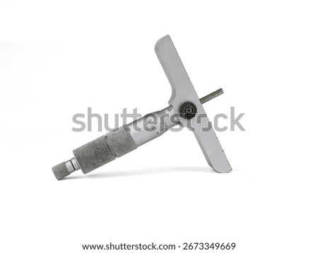 Depth micrometer on a white background. The silver and metallic gray precision measuring tool is shown at an angle, highlighting its scale and design.
