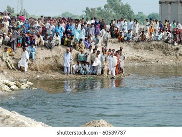 DERA ALLAHYAR, PAKISTAN-SEPT 02: Flood affected people, who were rescued by army officials at flood hit area, gather at Jan Jamali Bypass and wait for relief and food Sept 2, 2010 in Dera Allahyar
