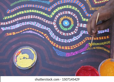 DERBY, WA - SEP 10 2019:Aboriginal Artist Dot Painting.Before Indigenous Australian Art Was Ever Put Onto Canvas The Aboriginal People Would Smooth Over The Soil To Draw Sacred Ceremony Designs.