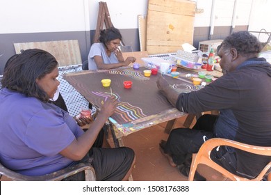 DERBY, WA - SEP 10 2019:Aboriginal artists dot painting.Before Indigenous Australian art was ever put onto canvas the Aboriginal people would smooth over the soil to draw sacred ceremony designs.