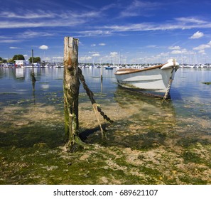 Derelict Boats In The Backwaters Of Holes Bay, Poole Harbour At Low Tide