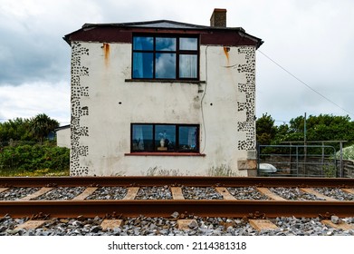 Derelict building close to railroad means sleepless nights. Abandoned dwelling or dilapidated house by a railway or train tracks. Architecture of a forgotten or forsaken home conveys solitude concept - Shutterstock ID 2114381318