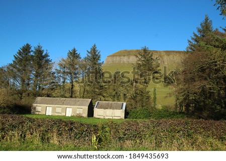 Derelict cottage and shed with Benbulben Mountain in background, County Sligo, ireland