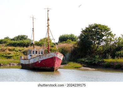 Derelict Fishing Boat On Foundry Reach Near Walton-on-the-Naze, Essex, UK.