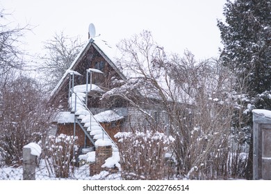 Derelict In Wintertime Cottage Style Summer House. Stairs To Second Floor Covered With Snow Never Swept