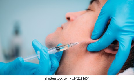 Dermal Filler Treatments For Men. Man Receives Dermal Filler Injections For Jawline.