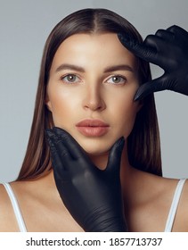 Dermatologist In Black Gloves Checking Woman's Face Before Plastic Surgery