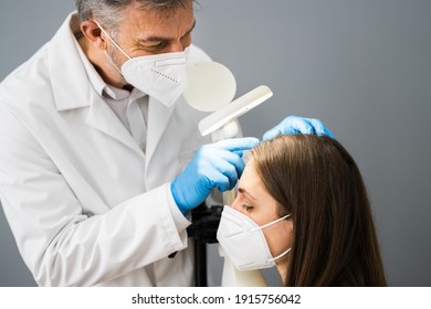 Dermatologist Doctor Checking Woman Hair For Dandruff In Face Mask