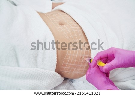 Dermatologist is doing injection into the subcutaneous fat in aesthetic clinic
