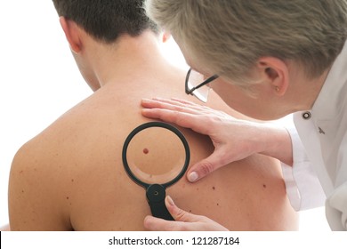 Dermatologist examines a mole of male patient - Powered by Shutterstock