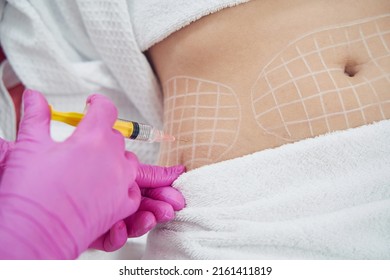Dermatologist performing non invasive fat reduction procedure in beauty center - Shutterstock ID 2161411819