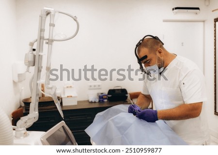 Dermatologist performs surgery to remove a mole on the back