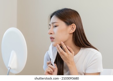 Dermatology, Puberty Asian Young Woman, Girl Looking Into Mirror, Allergy When Wear Mask And Cosmetic, Show Squeezing Pimple Spot For Removing From Face.Beauty Care From Skin Problem By Acne Treatment