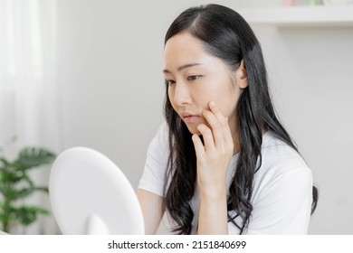 Dermatology, Puberty Asian Young Woman, Girl Looking Into Mirror, Allergic When Facial Dirty And Cosmetic, Show Squeezing Pimple Spot On Her Face. Beauty Care From Skin Problem By Acne Treatment.