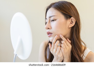 Dermatology, Puberty Asian Young Woman, Girl Looking Into Mirror, Allergy When Wear Mask And Cosmetic, Show Squeezing Pimple Spot For Removing From Face.Beauty Care From Skin Problem By Acne Treatment