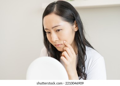 Dermatology, Puberty Asian Young Woman, Girl Looking Into Mirror, Allergy Presenting An Allergic Reaction From Cosmetic, Red Spot Or  Rash On Face. Beauty Care From Skin Problem By Medical Treatment.