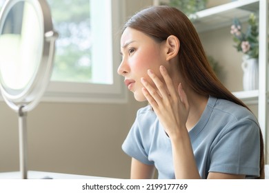 Dermatology, Scratch Asian Young Woman Looking At Mirror, Expression Worry And Itch, Itchy Allergy Or Allergic Sensitive Reaction, Red Spot Or Rash On Her Face. Beauty Care From Skin Problem Treatment