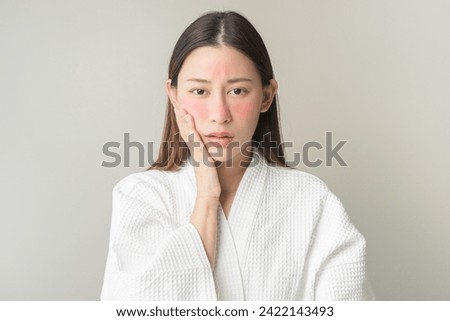 Dermatology, scratch asian young woman looking at camera, expression worry and itch, itchy allergy or allergic sensitive reaction, red spot or rash on her face. Beauty care from skin problem treatment