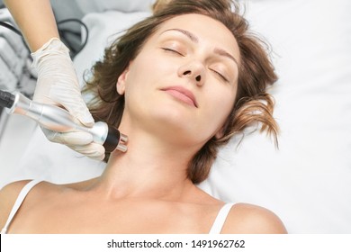 Dermatology skin care facial therapy. Medical spa anto wrinkles procedure. Woman face rejuvenation. Pretty girl. Rf cosmetician equipment. Chin and neck.