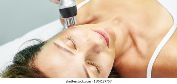 Dermatology skin care facial therapy. Medical spa anto wrinkles procedure. Woman face rejuvenation. Pretty girl. Rf cosmetician equipment.