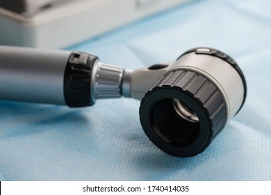 A dermatoscope is a medical device with lenses for examining moles and age spots for the presence of melanoma. Used in dermatology.