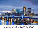 Des Moines, Iowa, USA downtown cityscape on the river at twilight.