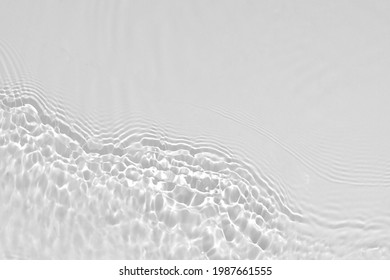 Desaturated transparent clear calm water surface texture with ripples, splashes Abstract nature background.