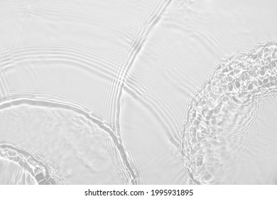 Desaturated transparent clear calm water surface texture with ripples, splashes Abstract nature background. White-grey water waves in sunlight Copy space Cosmetic moisturizer micellar toner emulsion - Shutterstock ID 1995931895
