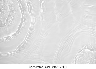 Desaturated transparent clear water surface texture with ripples, splashes Abstract nature background. White-grey water waves overlay Copy space, top view. Cosmetic moisturizer micellar toner emulsion - Shutterstock ID 2154497111