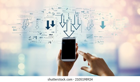 Descending arrows with person using a smartphone - Shutterstock ID 2105198924