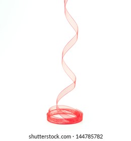 Descending Coiled Sheer Red Ribbon On A White Background